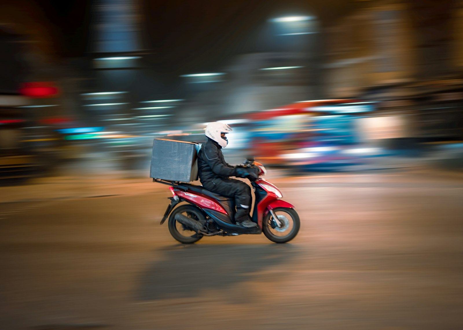 Motorbike courier at night